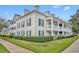 Two story building with light beige siding, dark gray shutters, and a wrap-around porch at 239 Longview Ave # 216, Celebration, FL 34747