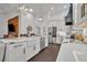 Modern kitchen with white cabinets, quartz countertops and a statement range hood at 239 Longview Ave # 216, Celebration, FL 34747