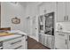Bright kitchen showcasing stainless steel refrigerator and pantry with glass door at 239 Longview Ave # 216, Celebration, FL 34747
