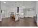 Open concept kitchen with island, white cabinets, and dark hardwood floors at 239 Longview Ave # 216, Celebration, FL 34747