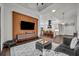 Open living room and kitchen with wood feature wall and comfortable seating at 239 Longview Ave # 216, Celebration, FL 34747