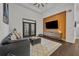 Living room with dark gray couch, wood accent wall, and a large TV at 239 Longview Ave # 216, Celebration, FL 34747