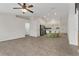 Open living room with tile floors and view of kitchen at 245 Captain Hook Way, Davenport, FL 33837