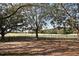 Backyard view of a golf course beyond a black metal fence at 2572 Robert Trent Jones Dr # 1231, Orlando, FL 32835