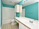Clean bathroom with teal walls, white tile, bathtub, and vanity at 2572 Robert Trent Jones Dr # 1231, Orlando, FL 32835