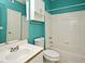 Bathroom with teal walls, white tile, and a tub at 2572 Robert Trent Jones Dr # 1231, Orlando, FL 32835