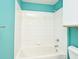 Bathroom with teal walls, white tile, bathtub, and shower at 2572 Robert Trent Jones Dr # 1231, Orlando, FL 32835