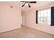 Bright bedroom with neutral walls, carpet, ceiling fan, and access to balcony at 2572 Robert Trent Jones Dr # 1231, Orlando, FL 32835