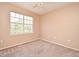 Bedroom with neutral walls, carpet, and a large window at 2572 Robert Trent Jones Dr # 1231, Orlando, FL 32835