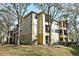Three-story building with yellow exterior and landscaping at 2572 Robert Trent Jones Dr # 1231, Orlando, FL 32835
