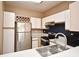 Kitchen with stainless steel appliances and white cabinets at 2572 Robert Trent Jones Dr # 1231, Orlando, FL 32835