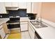 This kitchen features white cabinets, stainless appliances, and a double stainless steel sink at 2572 Robert Trent Jones Dr # 1231, Orlando, FL 32835