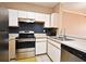 The kitchen features stainless steel appliances and white cabinets with stylish backsplash at 2572 Robert Trent Jones Dr # 1231, Orlando, FL 32835