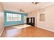 Living room featuring hardwood floors, large window, and ceiling fan at 2572 Robert Trent Jones Dr # 1231, Orlando, FL 32835