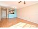 Bright living room features hardwood floors and a view into the kitchen area at 2572 Robert Trent Jones Dr # 1231, Orlando, FL 32835