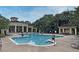 Relaxing community pool with lounge chairs and a clubhouse in the background at 2572 Robert Trent Jones Dr # 1231, Orlando, FL 32835