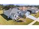 Aerial view of a single-story home with a grey roof, manicured landscaping, and a well-maintained lawn at 26812 Augusta Springs Cir, Leesburg, FL 34748