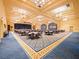 The community's ballroom with decorated tables, chairs, and a stage is well-lit and spacious at 26812 Augusta Springs Cir, Leesburg, FL 34748