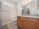 Well-lit bathroom featuring a tile floor, vanity with a light wood finish, and a shower-tub combo at 26812 Augusta Springs Cir, Leesburg, FL 34748
