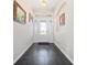 Elegant foyer featuring dark tile flooring and a front door with decorative glass at 26812 Augusta Springs Cir, Leesburg, FL 34748
