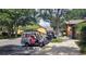 Handicap golf carts are ready for use near landscaped community amenities under mature trees at 26812 Augusta Springs Cir, Leesburg, FL 34748