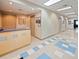 Well-lit hallway with blue tile accents leading to various rooms and amenities at 26812 Augusta Springs Cir, Leesburg, FL 34748