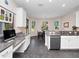 Bright kitchen with built-in workspace, granite countertops, and stainless steel appliances at 26812 Augusta Springs Cir, Leesburg, FL 34748
