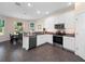 Bright kitchen features stainless steel appliances, granite countertops, and tiled floor at 26812 Augusta Springs Cir, Leesburg, FL 34748