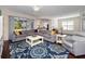 Spacious living room with a large sectional, ceiling fan, and open layout at 26812 Augusta Springs Cir, Leesburg, FL 34748