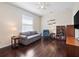 Comfortable living room featuring wood floors, a sofa, and a display cabinet at 26812 Augusta Springs Cir, Leesburg, FL 34748