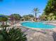 Resort-style pool area with lush landscaping, pergola, and plenty of lounge chairs for relaxing at 26812 Augusta Springs Cir, Leesburg, FL 34748