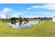 Serene lake view with grassy shoreline at 2887 Mosshire Cir, Saint Cloud, FL 34772