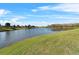 Calm water pond with lush green grass and trees at 2887 Mosshire Cir, Saint Cloud, FL 34772