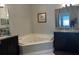 Double vanity bathroom with a corner jacuzzi tub at 3017 Cottage Grove Ct # Ge, Orlando, FL 32822