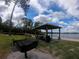 Community picnic area with grill, tables, and lake view at 3017 Cottage Grove Ct # Ge, Orlando, FL 32822