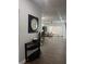 Bright entryway with dark wood accent table and mirror at 3017 Cottage Grove Ct # Ge, Orlando, FL 32822