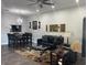 Spacious living room with dark furniture and wood-look floors at 3017 Cottage Grove Ct # Ge, Orlando, FL 32822