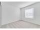 Cozy bedroom with soft carpet, neutral walls, and natural light from the window at 307 River Front Way, Edgewater, FL 32141