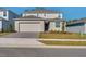 Two-story home with a well-manicured front yard and a two-car garage at 307 River Front Way, Edgewater, FL 32141