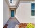 Inviting front entryway featuring a blue front door, stone walkway, and modern design elements at 307 River Front Way, Edgewater, FL 32141