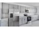 Modern kitchen with stainless steel appliances, grey cabinets, and quartz countertops at 307 River Front Way, Edgewater, FL 32141