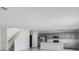 Open-concept living space seamlessly connects the kitchen and staircase with tons of natural light at 307 River Front Way, Edgewater, FL 32141