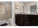 Elegant bathroom with dark brown vanity and a spacious shower at 3937 Lana Ave, Davenport, FL 33897
