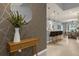Bright entryway with geometric wallpaper, console table, and view of the dining area at 3937 Lana Ave, Davenport, FL 33897