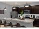 Modern kitchen with an island, dark cabinets, stainless steel appliances and granite countertops at 3937 Lana Ave, Davenport, FL 33897