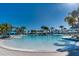 Large resort-style pool with multiple lounging areas and palm trees at 3937 Lana Ave, Davenport, FL 33897
