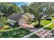 Aerial view of house with large tree and brick driveway at 5011 Winwood Way, Orlando, FL 32819