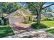 House with a large yard and brick driveway at 5011 Winwood Way, Orlando, FL 32819