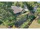Backyard with large trees and fenced-in garden area at 5011 Winwood Way, Orlando, FL 32819