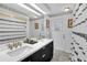 Bathroom with double vanity, black cabinets, and gold accents at 5011 Winwood Way, Orlando, FL 32819